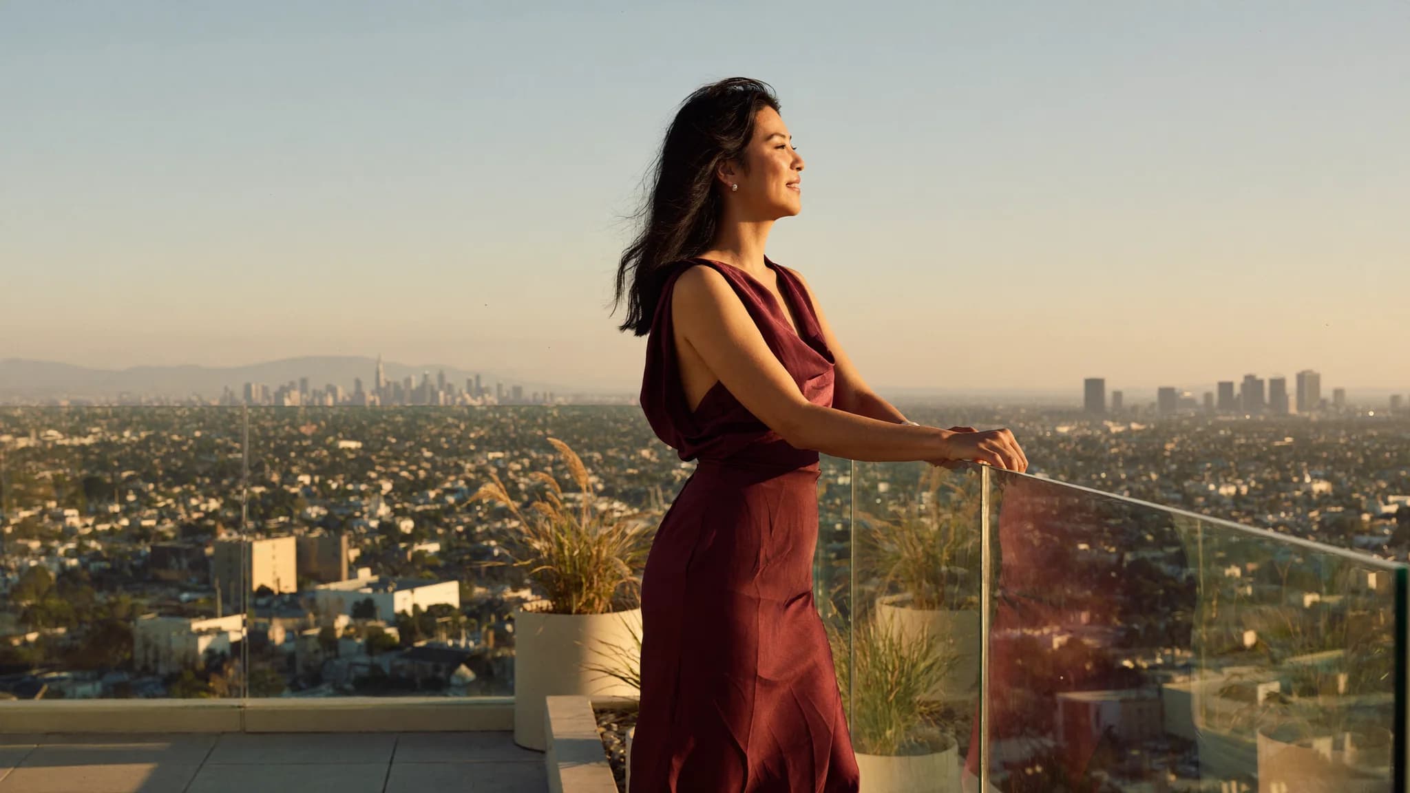 Eugene Ahn on a rooftop at golden hour, the city below